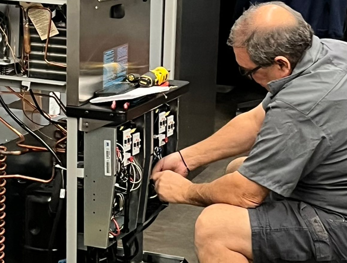 Service Technician does diagnostics on kitchen equipment
